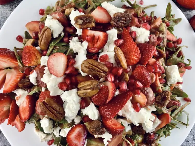 Toppings added to strawberry goat cheese salad.