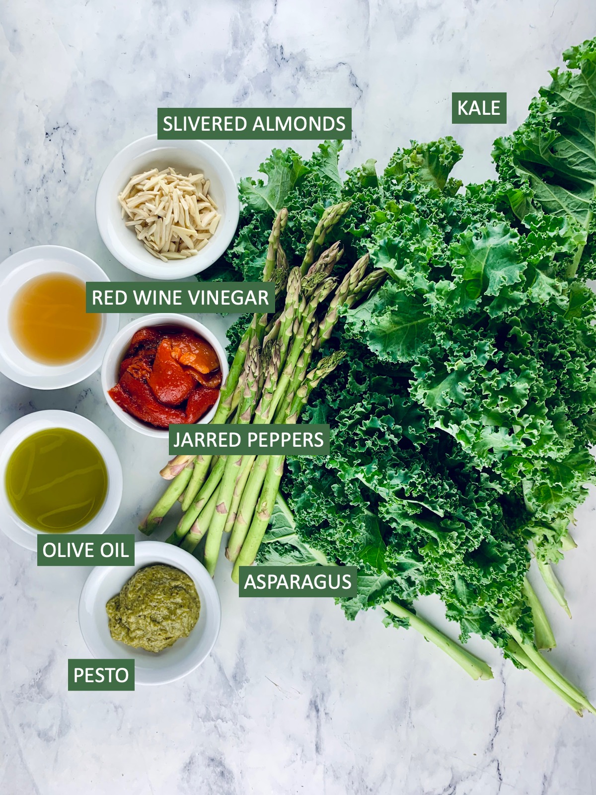 Labelled ingredients needed to make a Grilled Asparagus Kale Salad.