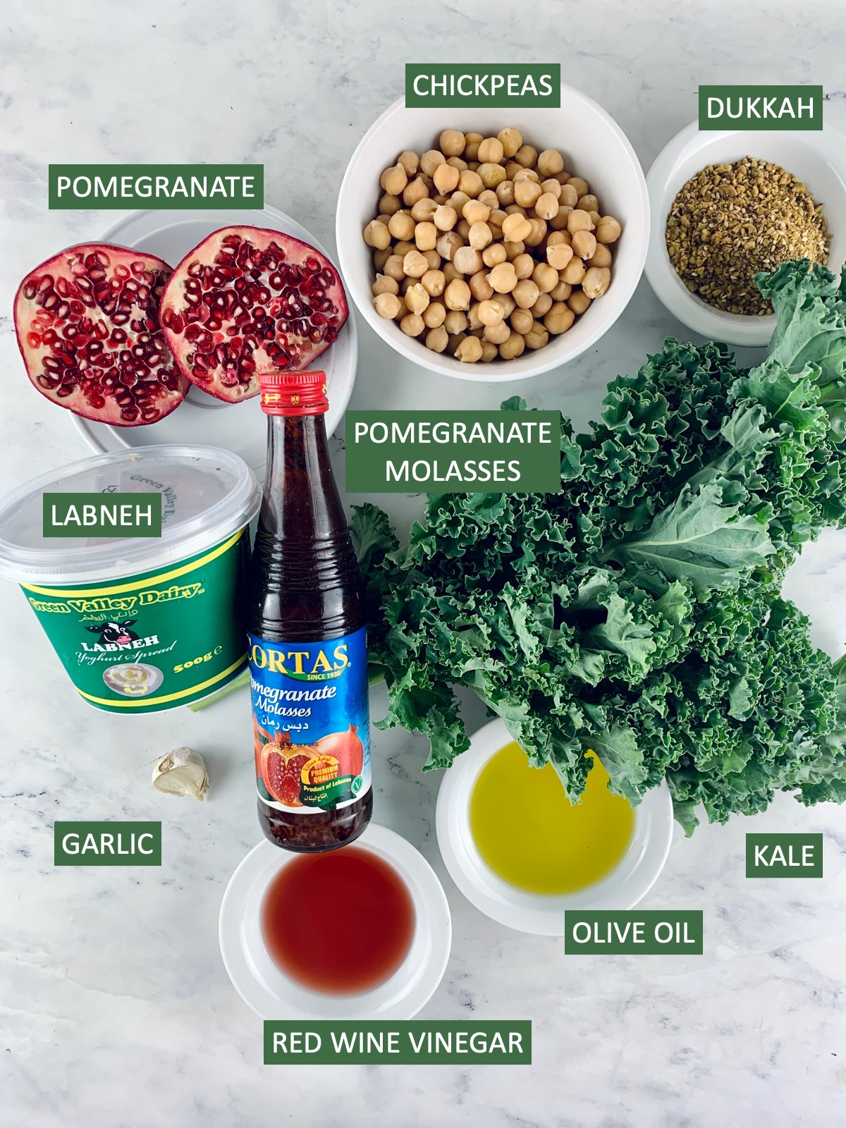Labelled ingredients needed to make kale pomegranate salad.