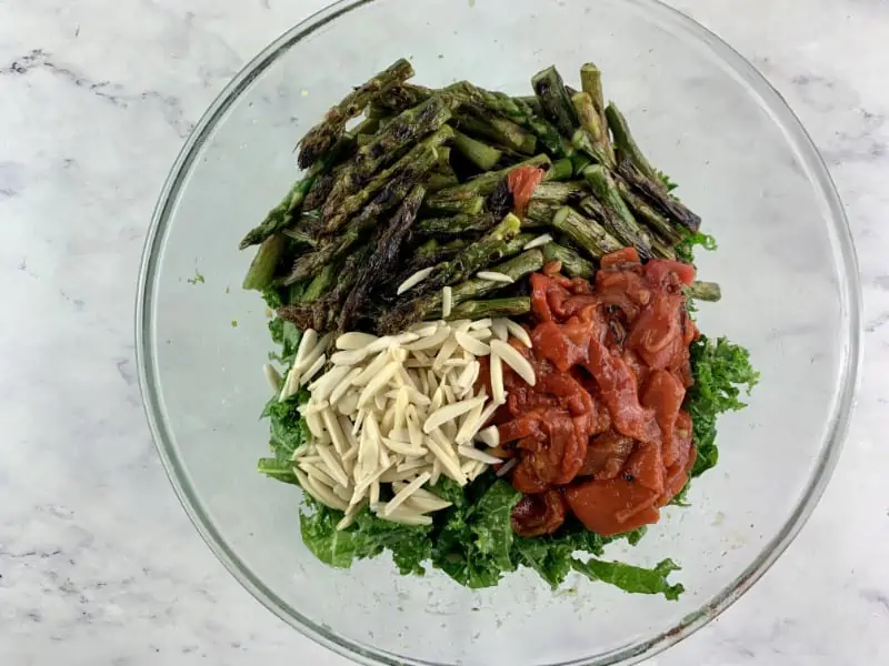 Prepared Asparagus Kale salad ingredients in a glass bowl.