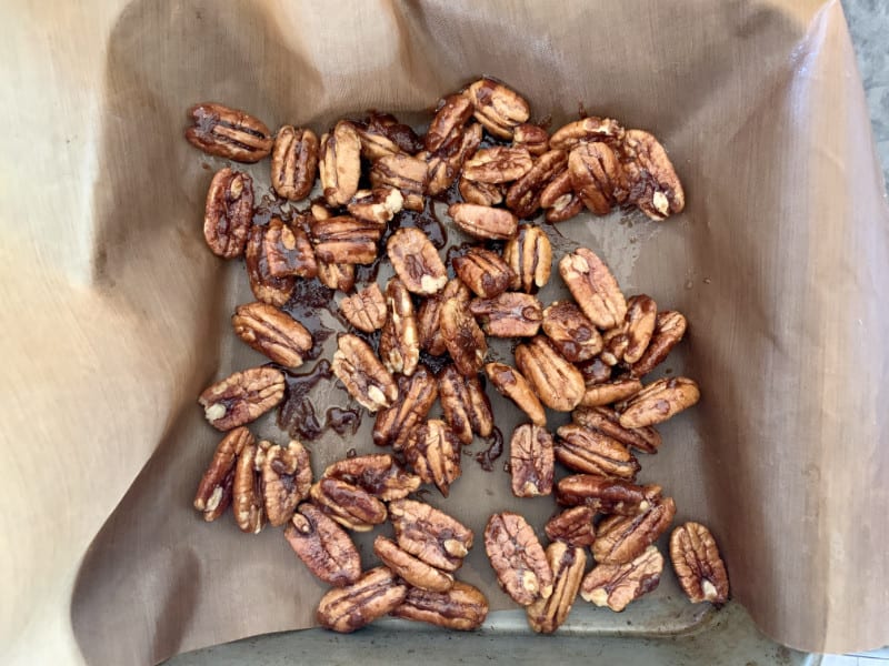 Candied pecans on paper to cool.