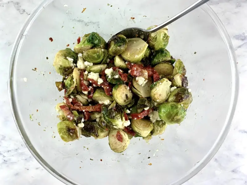 Mixing Roasted brussel sprout salad.