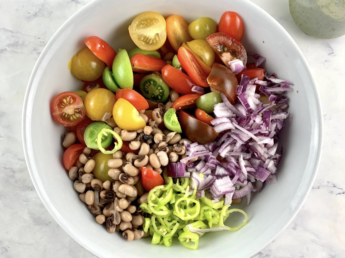 Prepared Black-Eyed Bean Salad ingredients in a white bowl.
