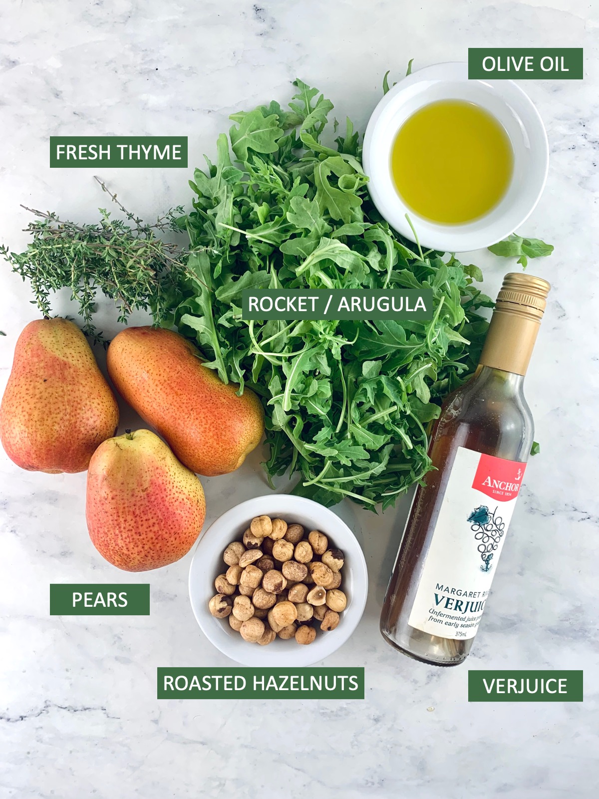 Labelled ingredients needed to make a pear and rocket salad.