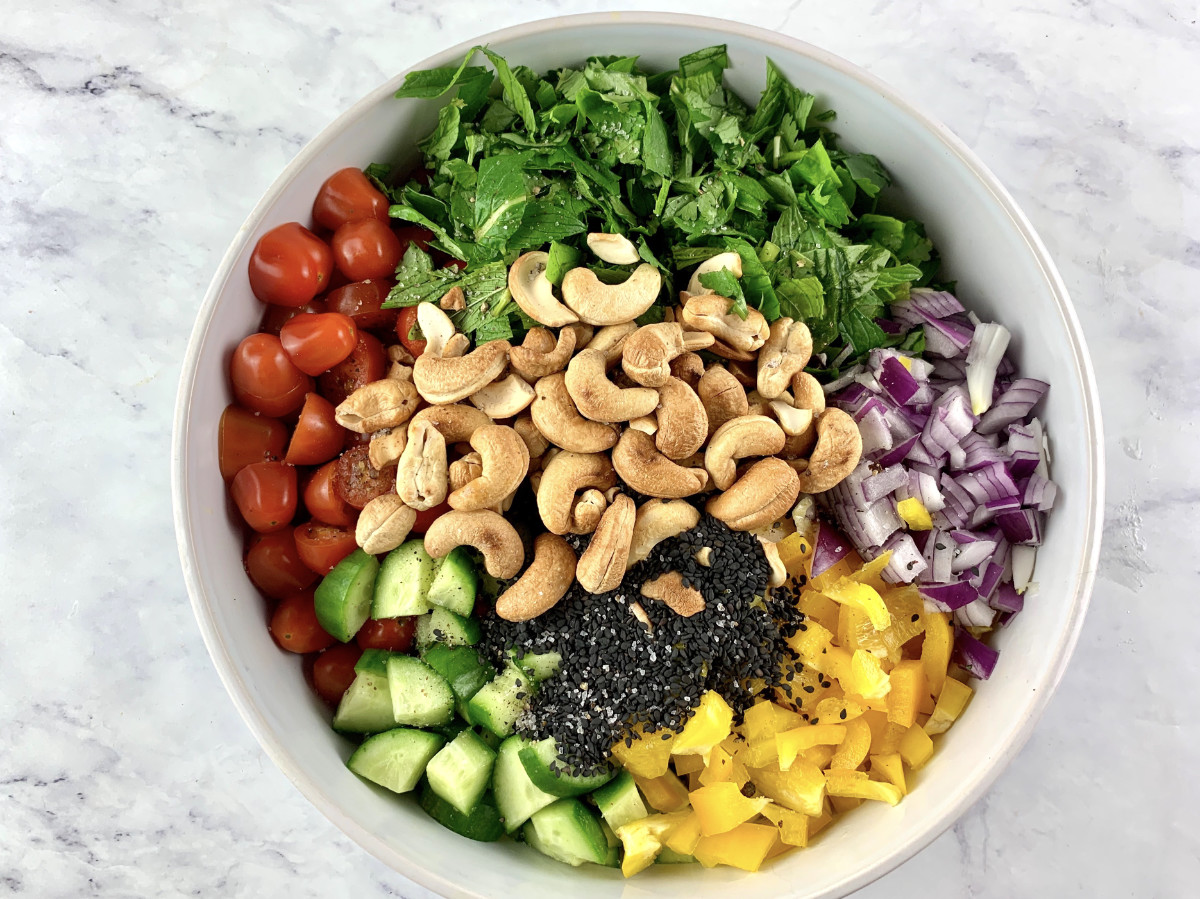 Prepared Asian chopped salad ingredients in a white bowl.