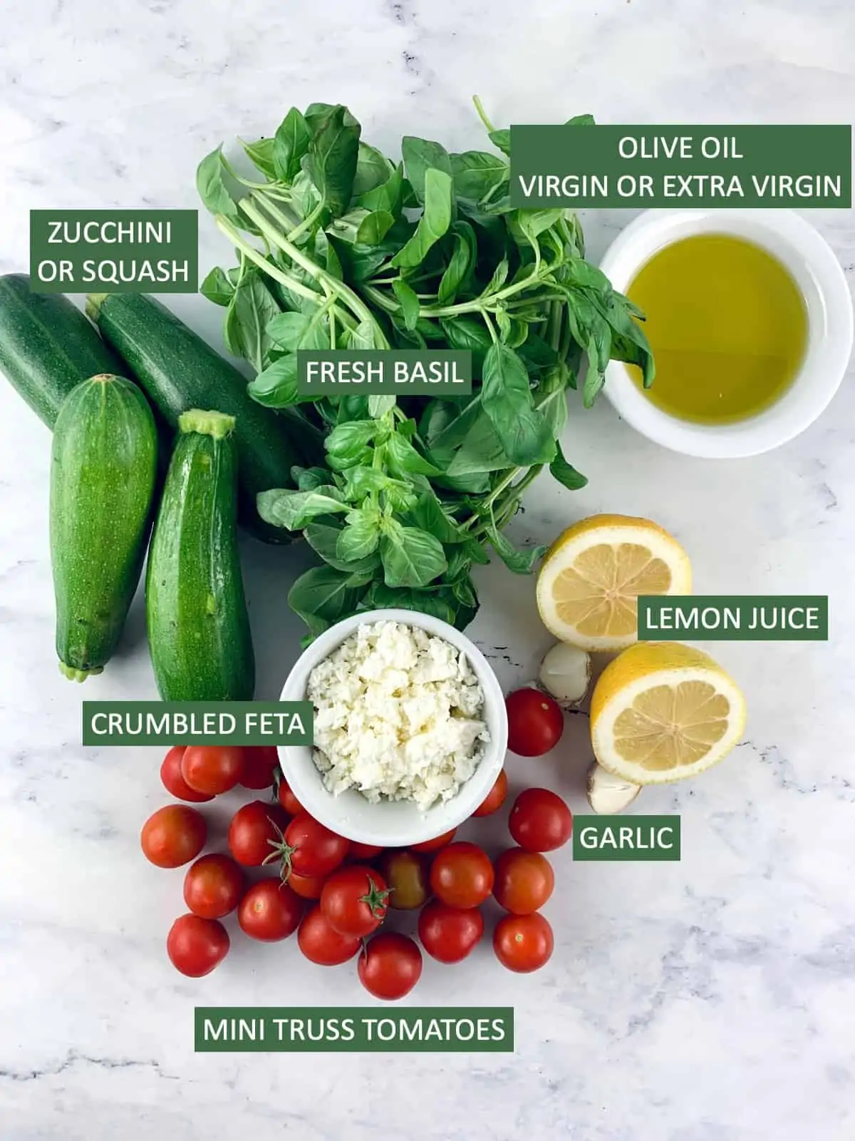 Labelled ingredients needed to make a zucchini tomato salad.