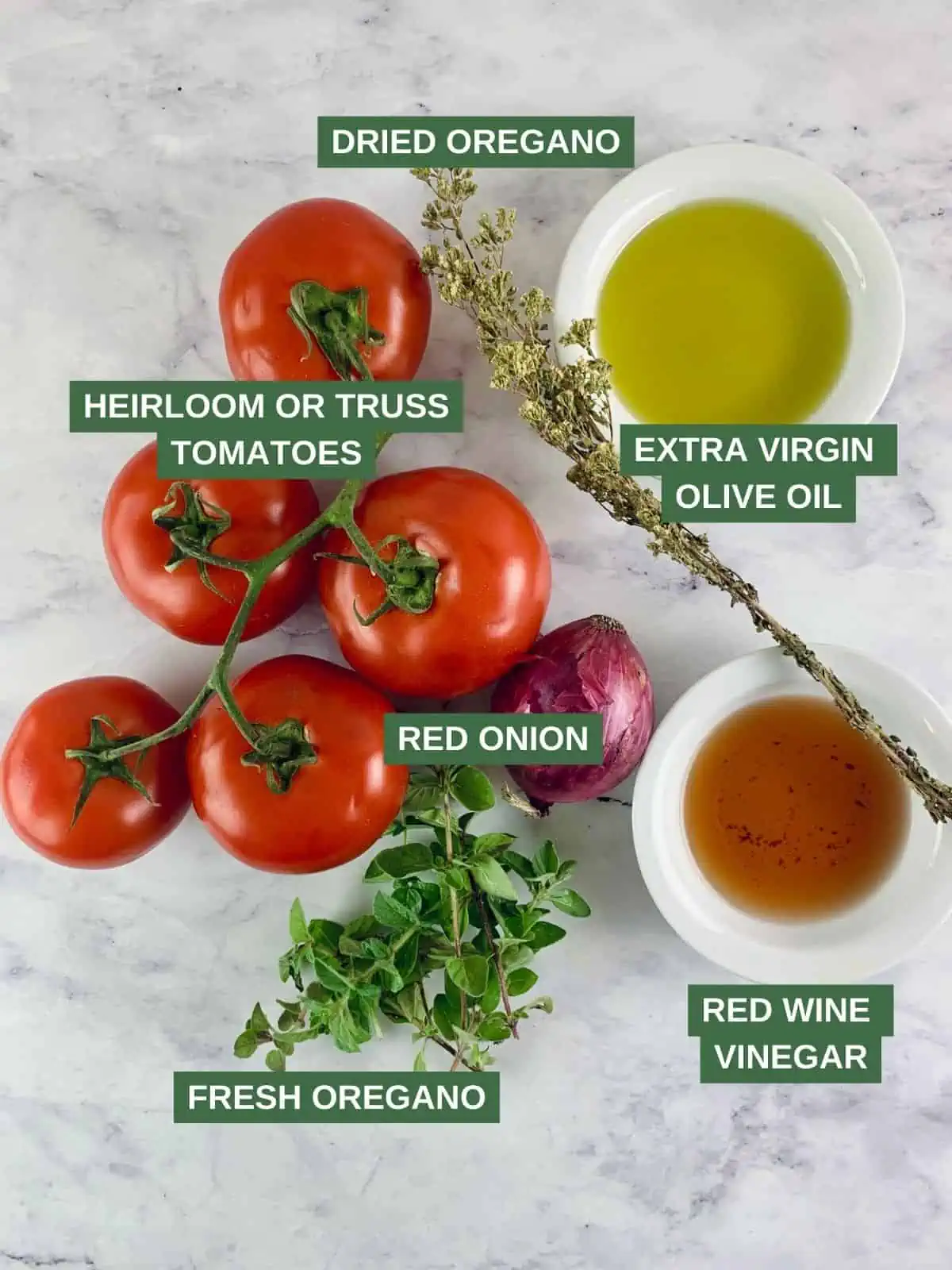 Labelled ingredients needed to make a tomato salad with oregano.