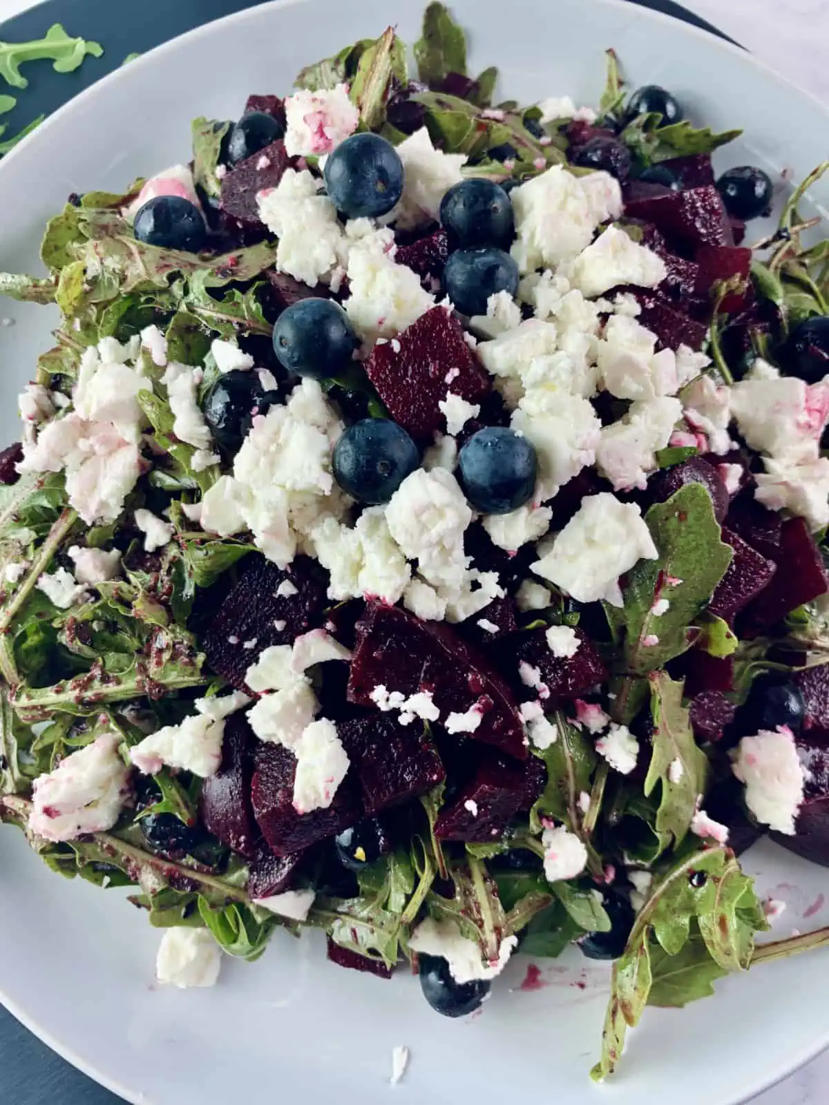 A close-up of our red white and blue salad on a white plate.
